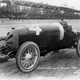 Gaston Chevrolet sits with Johnny Bresnahan in his race car during a practice day prior to the 1920 Indianapolis 500. Photo credit: IMS via AP